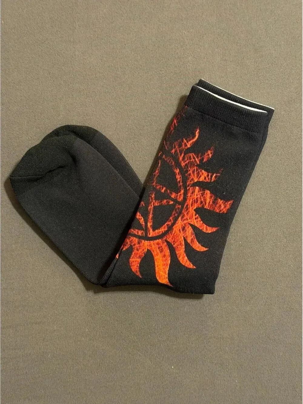 Supernatural socks featuring red anti possession symbol